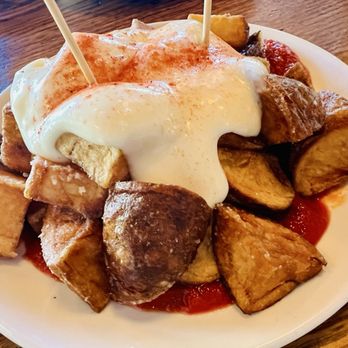 Barcelona Wine Bar - Patatas bravas - salsa bravas at the bottom & garlic aioli on top - Wine Bars Near Me - Houston, Texas Barcelona Wine Bar - Patatas bravas - salsa bravas at the bottom & garlic aioli on top - Wine Bars Near Me - Houston, Texas