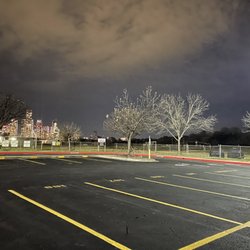 Stephen F Austin High School - Parking lot with track behind and view of downtown