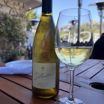 Cafe Rustica - a glass of white wine and a bottle of wine - French Near Me - Carmel Valley, California Cafe Rustica - a glass of white wine and a bottle of wine - French Near Me - Carmel Valley, California