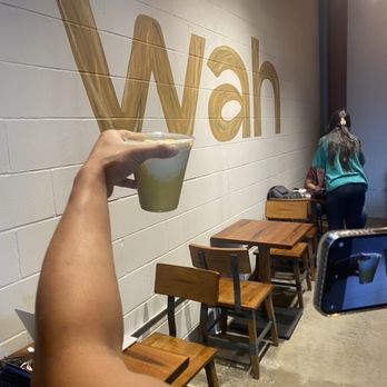 Wah Coffee - Mango yogurt (in hand), designated work/study area (in pic) - Coffee & Tea Near Me - Richmond, Texas