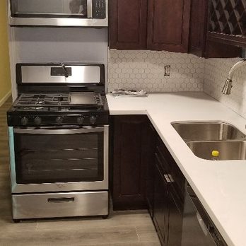 C-H Construction - a kitchen with stainless steel appliances - General Contractors Near Me