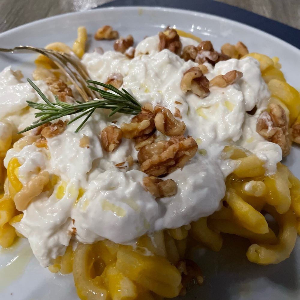Homemade pasta topped with homemade sauce & homemade cheese .