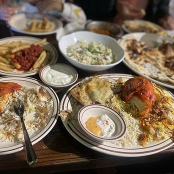 Alyemen Alsaeed - I probably should've taken the photo before we ate :)  -chicken Mandi  -lamb Mandi  -Aden fries  -veggie salad  -khubz -masoob -arika - Middle Eastern Near Me - Chicago, Illinois