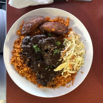 Wakanda Lounge - Lamb with jollof rice with plantain and slaw. - African Near Me - Greenville, South Carolina Wakanda Lounge - Lamb with jollof rice with plantain and slaw. - African Near Me - Greenville, South Carolina