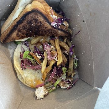 Dockside Grill - Shrimp taco. Grilled cheese and fried. - A sandwich with toasted bread, fries, and a side salad with purple cabbage and greens in a brown takeout box. - New American Near Me - Falmouth, Maine