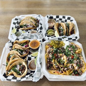 La Iguana - three trays of tacos on a table - Tacos Near Me - Navarre, Florida La Iguana - three trays of tacos on a table - Tacos Near Me - Navarre, Florida