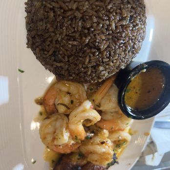 Rebel - Signature Barbancourt Shrimp: sauteed & tossed in tomatoes, and herbs served with djon djon rice and Sweet Plantains. - Haitian Near Me - New York, New York Rebel - Signature Barbancourt Shrimp: sauteed & tossed in tomatoes, and herbs served with djon djon rice and Sweet Plantains. - Haitian Near Me - New York, New York