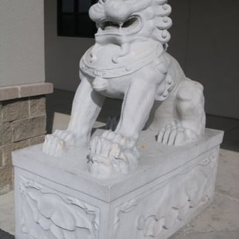 August Moon - a statue of a lion on a pedestal - Chinese Near Me - Murray, Kentucky
