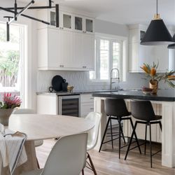 Arhaus - Arhaus Modina travertine table & Gage black counter stools.