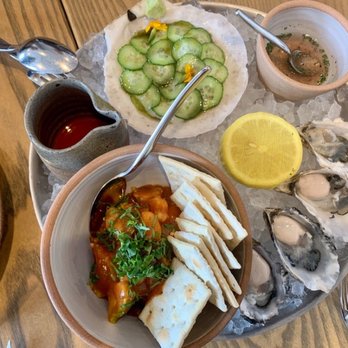 Ernest - Starters of raw oysters, scallop shashimi, and shrimp "coctel" with avocado, cilantro, & saltines - New American Near Me - San Francisco, California