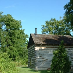 Cobblestone Farm and Museum - A small log cabin behind the main house and the barn at Cobblestone Farm.