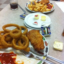 a plate of fried fish and onion rings with ketchup and ketchup a plate of fried fish and onion rings with ketchup and ketchup