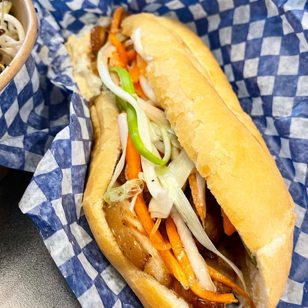 a sub sandwich and a bowl of coleslaw