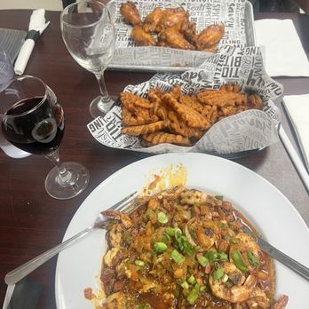 Steamers Clam Bar & Grill - Shrimp grits special, sweet potato waffle fries, chicken wings. - Seafood Near Me - Cedar Key, Florida Steamers Clam Bar & Grill - Shrimp grits special, sweet potato waffle fries, chicken wings. - Seafood Near Me - Cedar Key, Florida