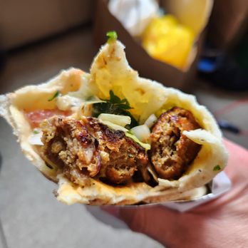 Master Chef's Kabob House - a hand holding a pita - Food Trucks Near Me - Vancouver, British Columbia Master Chef's Kabob House - a hand holding a pita - Food Trucks Near Me - Vancouver, British Columbia