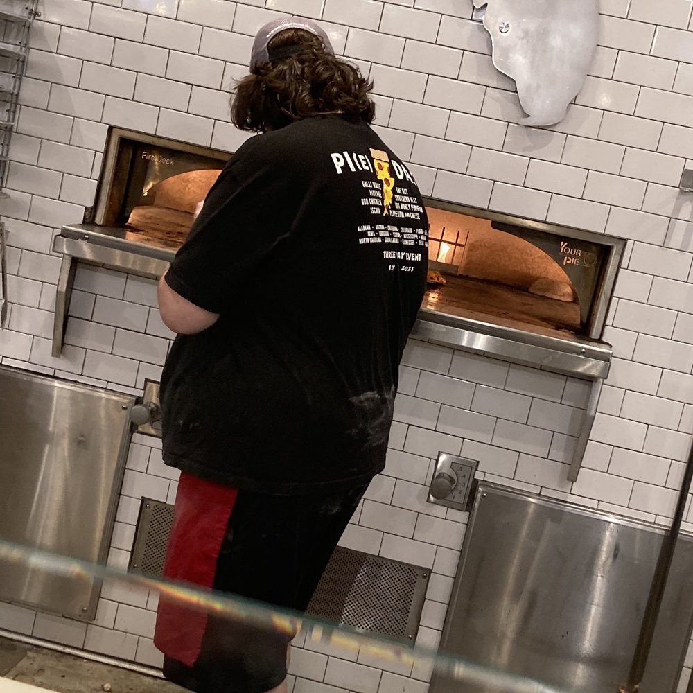 Putting pies in the oven. Putting pies in the oven.