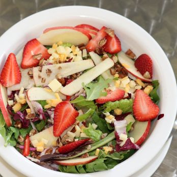 Indigo Organic - a bowl of salad with strawberries, apples, and nuts - Hair Salons Near Me - Mankato, Minnesota