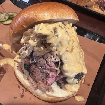 Smokehouse 41 - Side view of the fresh bun, sauce, onions and BEEF! Sasquatch style - Barbeque Near Me - Oakhurst, California