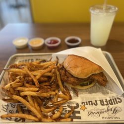 Simple chicken sandwich, Cajun fries, lemonade and sauces line up