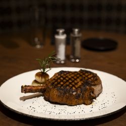 Revel Steak - A perfectly grilled Cowboy Ribeye with bold seasoning, signature grill marks and rich, savory flavor, served at Revel Steak.