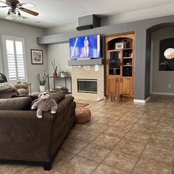 Xtreme Interiors - Before photo of fireplace/tv wall and flooring.