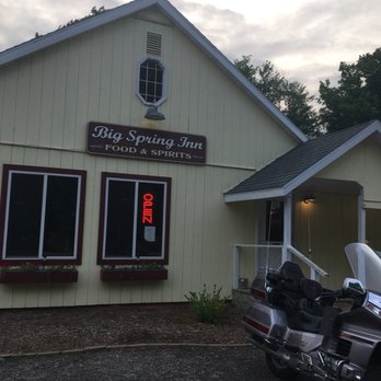 Big Springs Inn - a motorcycle parked in front of a building - American Near Me - Manistique, Michigan