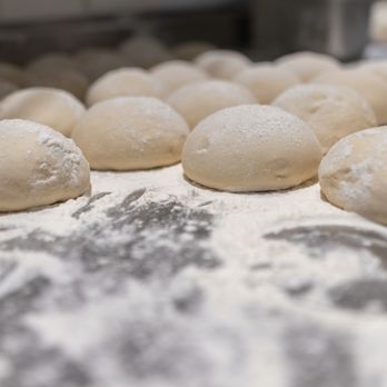 Crust Pizza - dough on a floured surface - Pizza Near Me - Richmond, Texas Crust Pizza - dough on a floured surface - Pizza Near Me - Richmond, Texas