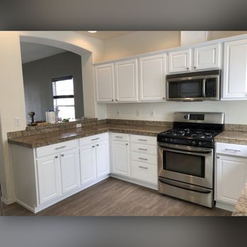 Bradley Paint Company - Wood to white with the addition of door hardware can transform a dated kitchen. - Painters Near Me