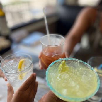 Costas Restaurant - two people holding drinks and a margarita - Greek Near Me - Tarpon Springs, Florida
