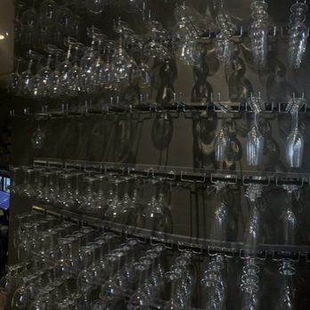 Paris 7th - Wall of wine glasses - French Near Me - Fort Worth, Texas