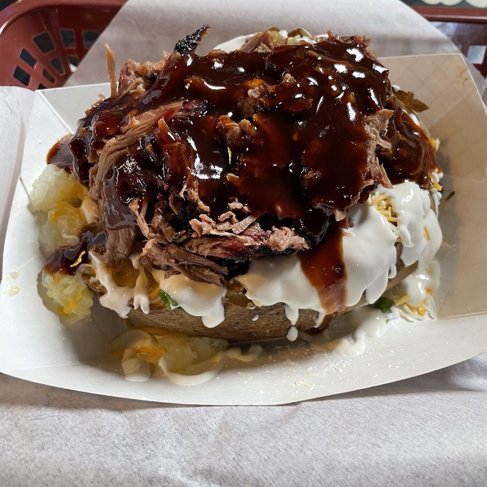 This is the loaded baked potato with brisket on top. A a little bit of bbq sauce. This is the loaded baked potato with brisket on top. A a little bit of bbq sauce.