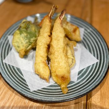 Yoshi Sushi - a plate of food on a wooden table - Sushi Bars Near Me - Los Altos, California