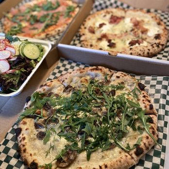 Vera - two pizzas and a salad on a table - Pizza Near Me - Winnipeg, Manitoba Vera - two pizzas and a salad on a table - Pizza Near Me - Winnipeg, Manitoba