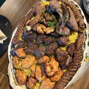 Almarah Mediterranean Cuisine - Family platter after the bread topper was removed. Included shrimp, beef, lamb chops, chicken and rice. Delicious! - Mediterranean Near Me - Austin, Texas