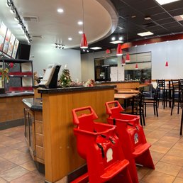 the interior of a restaurant with red chairs the interior of a restaurant with red chairs