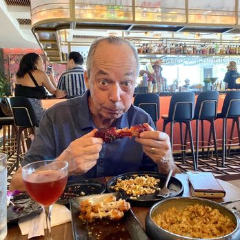 The Moderne - Happy person eating rib. - Tapas/Small Plates Near Me - Orlando, Florida The Moderne - Happy person eating rib. - Tapas/Small Plates Near Me - Orlando, Florida