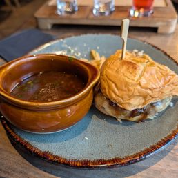 Half of the wagyu birria burger. It was soo good that I kept eating it before I remembered the picture. Duck fat fries are a must!