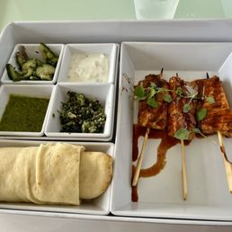Salmon kabob with pita bread, yogurt, cucumber salad and salsa Salmon kabob with pita bread, yogurt, cucumber salad and salsa