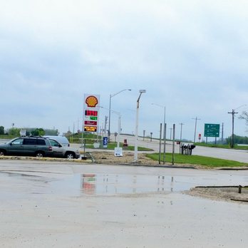 The New Oasis - a wet parking lot with a gas station in the background - New American Near Me - Ottawa, Illinois