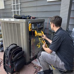 TopServ Appliance and HVAC - Servicing an HVAC condensing unit to keep the system running efficiently and reliably.