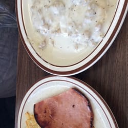 M C's Country Cafe - Biscuits and gravy with a side of hashbrowns and ham.