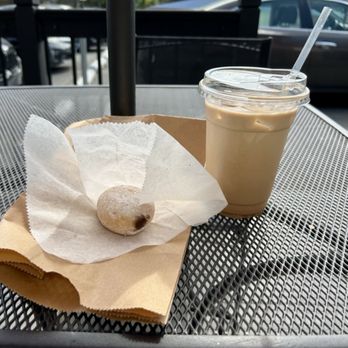 Old Mill Cafe - A fresh brioche-like powdered-sugar-coated jelly donut and creamy fresh hot coffee in and enclosed courtyard - Coffee & Tea Near Me - Ellicott City, Maryland