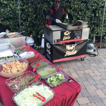 The Taco Guy Catering - Carlos and Laura Working on cooking a wide range of Tacos from Chicken to Carne Asada and all the trimmings - Caterers Near Me - Pasadena, California