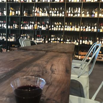 VinoTeca - a glass of wine on a wooden table - Wine Bars Near Me - Atlanta, Georgia
