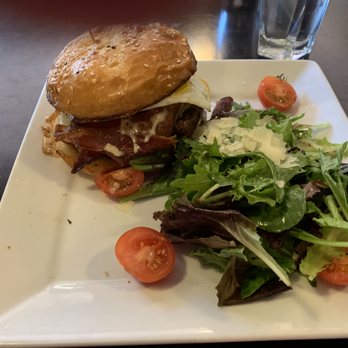 Flat Iron Grill - F.I.GBurger: rib steak blend,smoked bacon, fontina cheese, tomato, truffle aioli, macrina brioche bun with a salad on side and a sunny side - Steakhouses Near Me - Issaquah, Washington Flat Iron Grill - F.I.GBurger: rib steak blend,smoked bacon, fontina cheese, tomato, truffle aioli, macrina brioche bun with a salad on side and a sunny side - Steakhouses Near Me - Issaquah, Washington