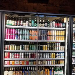One of their fridges filled with Sours & Lagers, each cooler is labeled up top with the type of drinks. One of their fridges filled with Sours & Lagers, each cooler is labeled up top with the type of drinks.