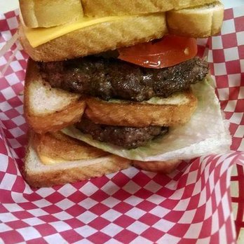 Still Four Corners - For those BIG appetites, a gut busting Grizzlly burger with 2 half pound burgers! - Sports Bars Near Me - Hopkinton, Iowa Still Four Corners - For those BIG appetites, a gut busting Grizzlly burger with 2 half pound burgers! - Sports Bars Near Me - Hopkinton, Iowa