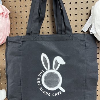 Hop Along Cafe - a black tote bag with a white rabbit on it - Pet Adoption Near Me - Pittsburgh, Pennsylvania