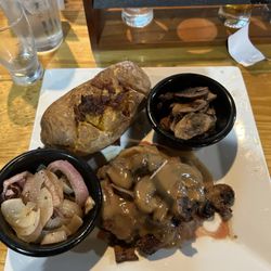 Benson's Steakhouse & Taproom - Hamburger steak with loaded potatoe and onions and mushrooms.