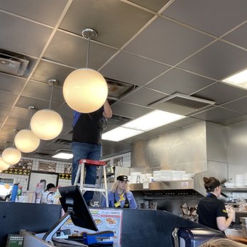 Waffle House - Employee up in false ceiling removing an old vent while just above the stove and griddle - Breakfast & Brunch Near Me - Parker, Colorado Waffle House - Employee up in false ceiling removing an old vent while just above the stove and griddle - Breakfast & Brunch Near Me - Parker, Colorado
